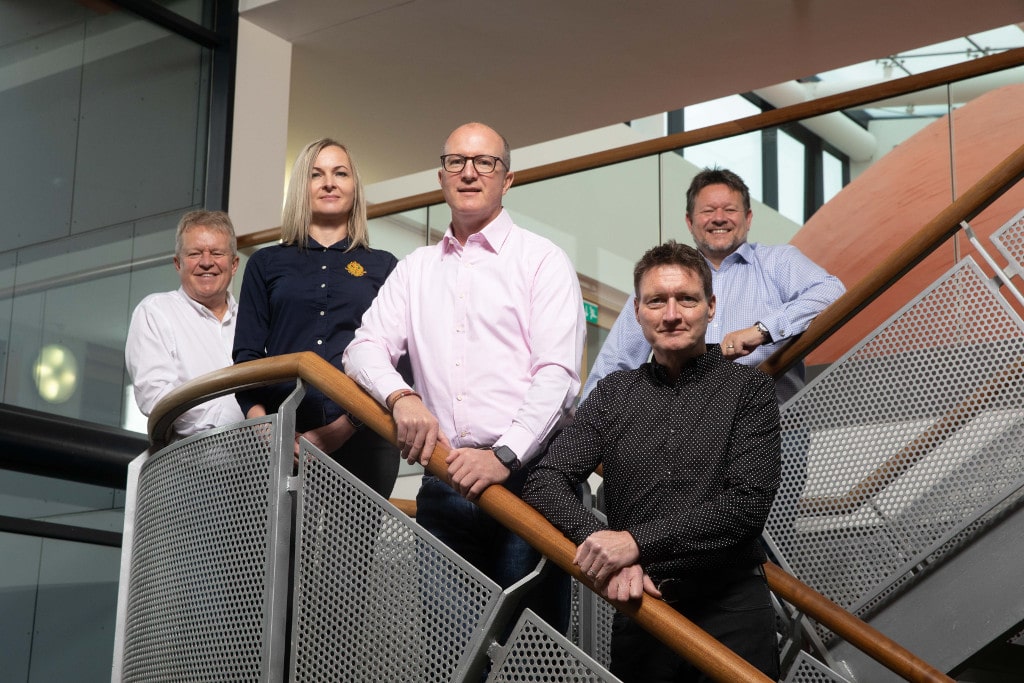 employees stood on a staircase